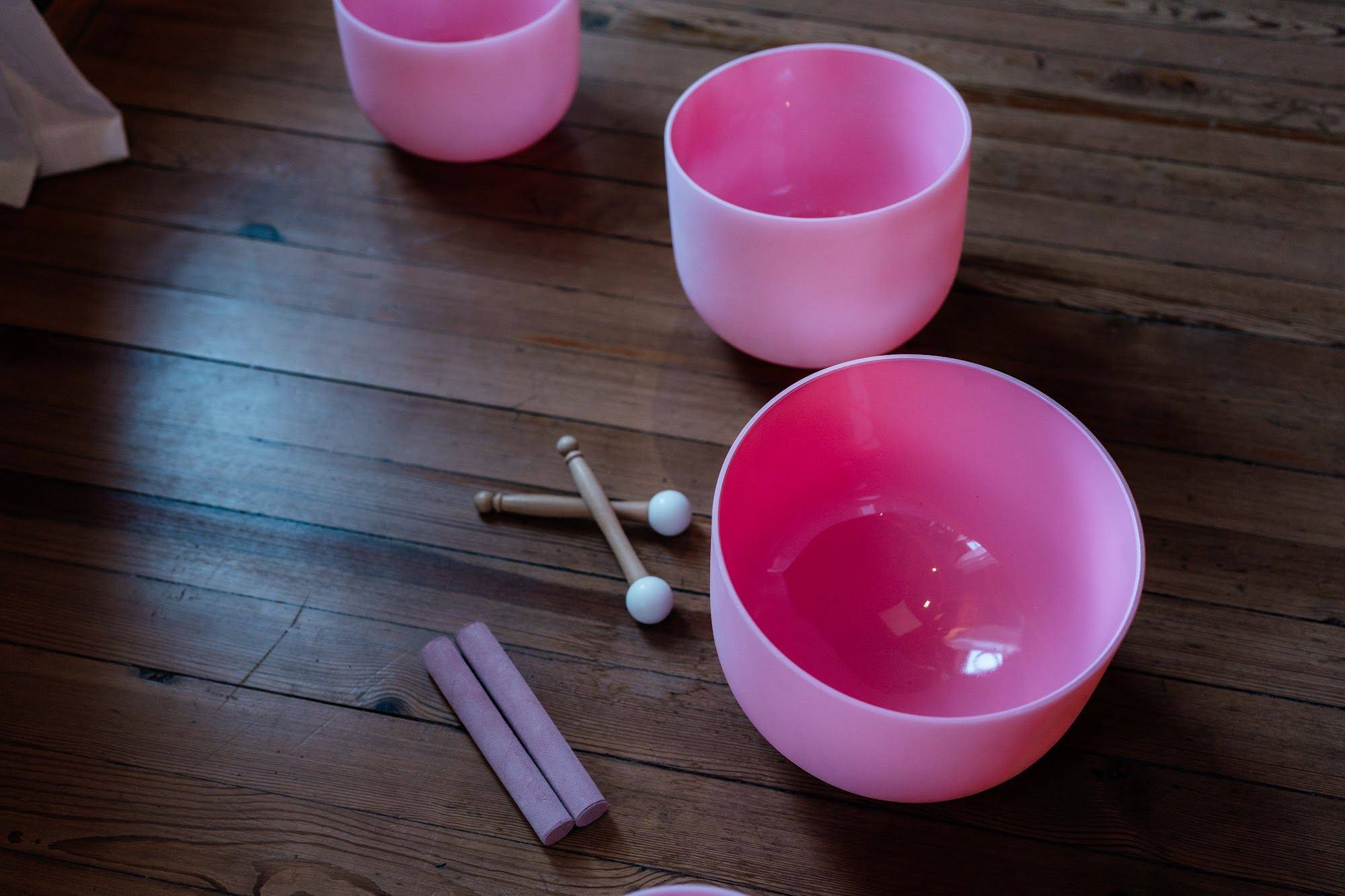 Blush crystal singing bowls on the floor