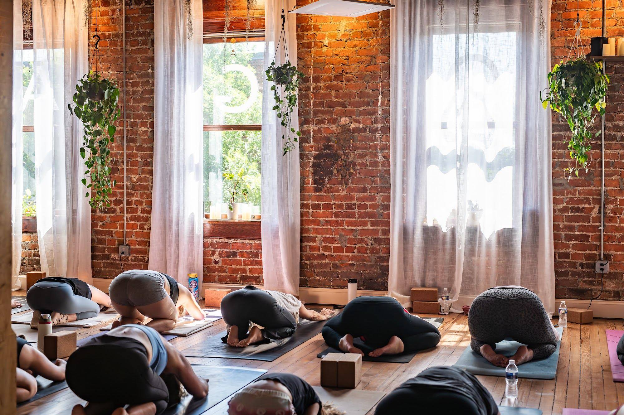 A full room resting in child's pose